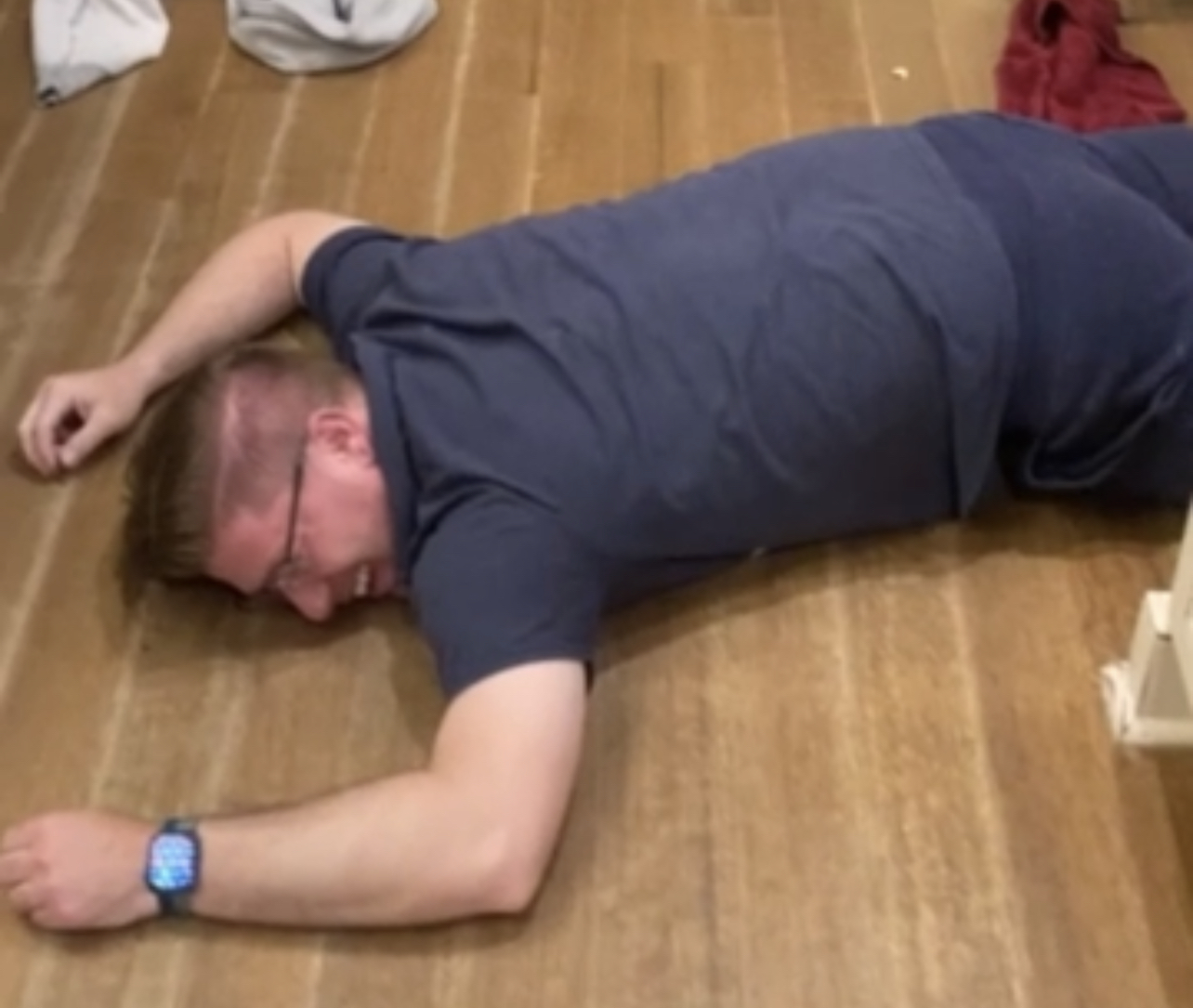 Chris Miller, prostrate on hardwood